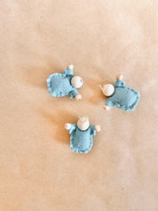Tiny felt worry dolls, comforting companions designed to help children with big worries.
